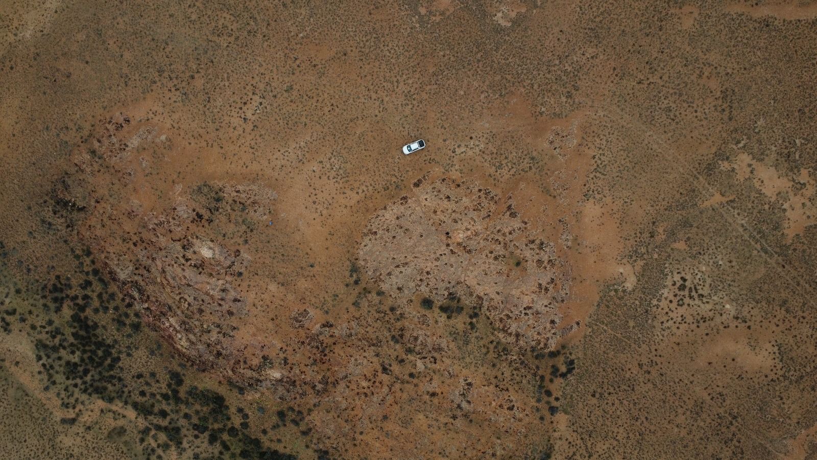 Aerial view of the Luna Roja property with a field vehicle on the plateau