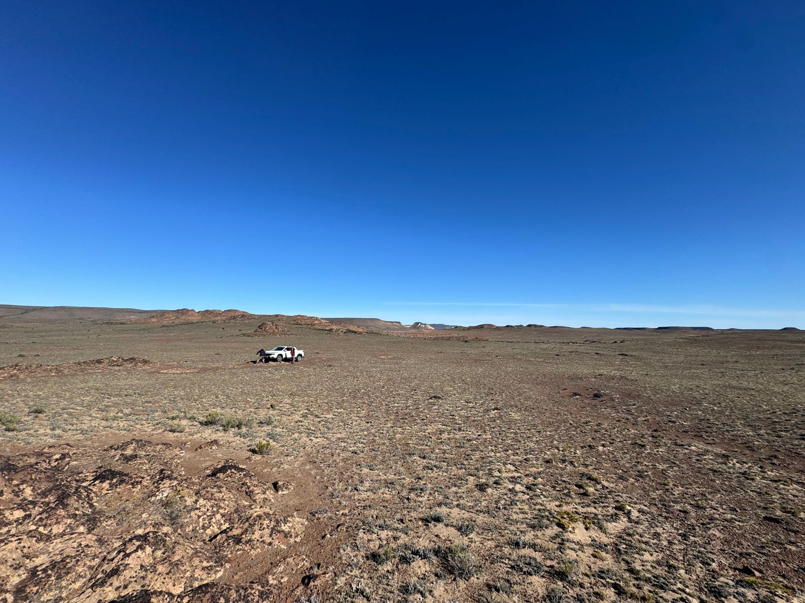 Field team and vehicle on the open Patagonian steppe